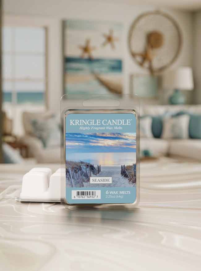 Kringle Candle seaside wax melt packaging on a table with a blurred beach-themed room in the background